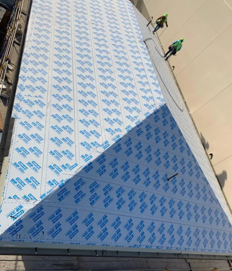 Professional roofers installing underlayment on a metal roof in Maurice River